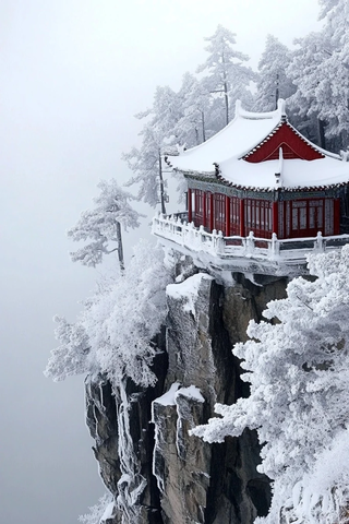 悬崖边被雪覆盖的中式红顶建筑